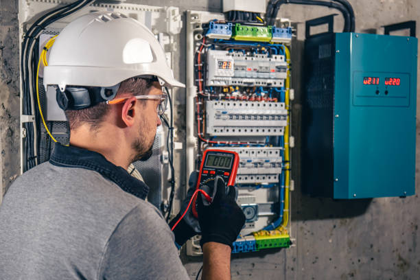istock Man, an electrical technician working in a switchboard with fuses. 1434211817