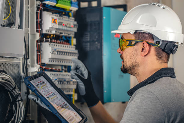 istock Man, an electrical technician working in a switchboard with fuses. 1434211819