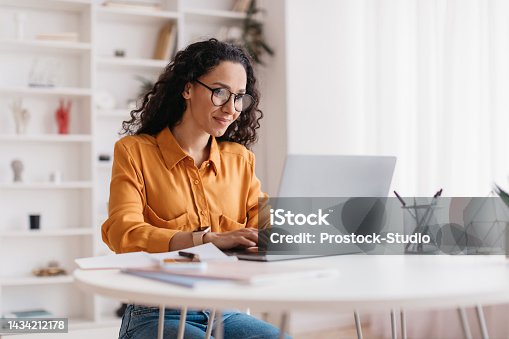 istock Middle Eastern Lady Using Laptop Working Online Sitting In Office 1434212178