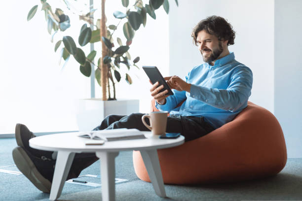 istock Portrait of smiling man using digital tablet at office 1434213808