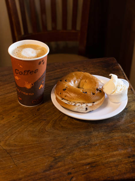 istock Coffe and a Bagel on Wood Table 1434214226