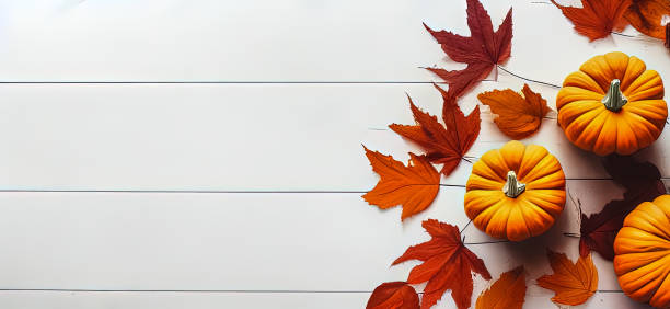 istock Halloween Pumpkin with autmn decoration leaves down view on white floor 1434216251