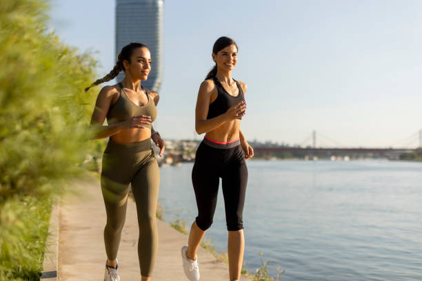 istock Young woman taking running exercise by the river promenade 1434218041