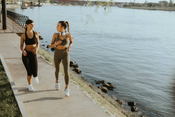 istock Young woman taking running exercise by the river promenade 1434218047