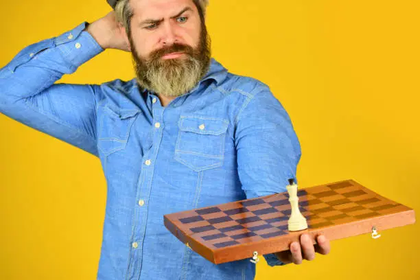 Chess figure. Intellectual game. Grandmaster player. Chess lesson. Cognitive development. Enjoy tournament. Strategy concept. Chess competition. Board game. Thoughtful bearded man play chess.