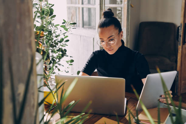 istock Beautiful woman using technologies while sitting at her working place in office 1434218279