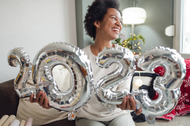 Happy new 2023. year African-American woman holds balloon numbers as a symbol of celebrating New Year 2023. new year resolution stock pictures, royalty-free photos & images
