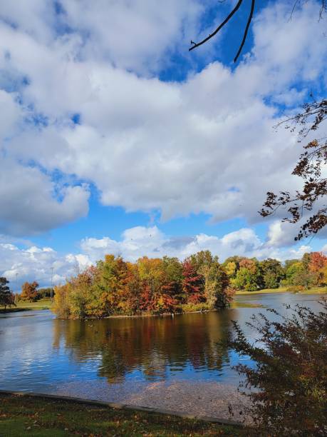 istock Autumn treed island reflecting over lake 1434220758