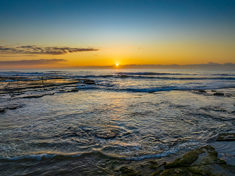 Sunrise over the ocean at Flat Rock beach nxt to the ocean baths in Newcastle, NSW, Australia.