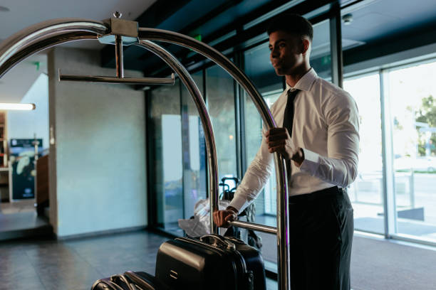 istock Hotel staff with luggage cart. 1434225171