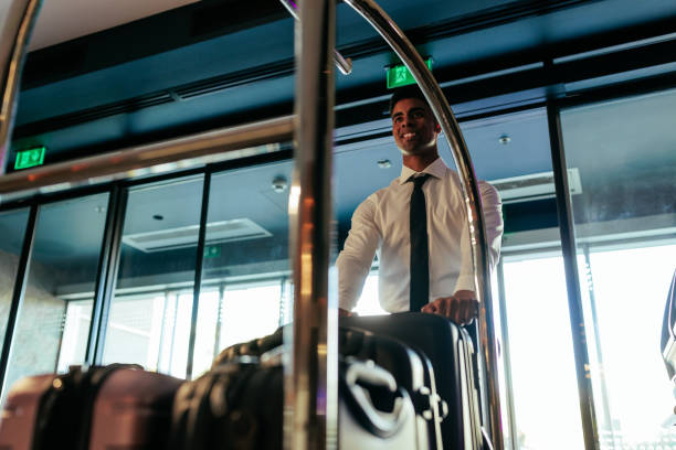 istock Happy hotel attendant with luggage. 1434225358