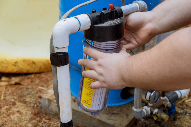 istock Water filter replacement is done by professionals in order to ensure that water stays clean in the outside area near the residence. 1434226417