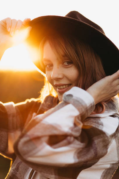 istock A beautiful cheerful woman in a hat at sunset 1434228252