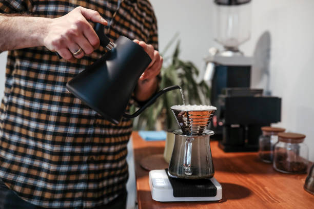 istock Barista Meticulously Pours Hot Water Into Filter Coffee 1434230707