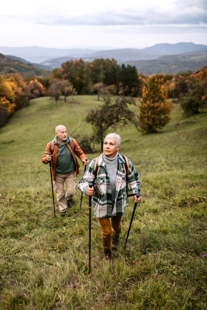 istock Senior couple climbing hill together 1434234727