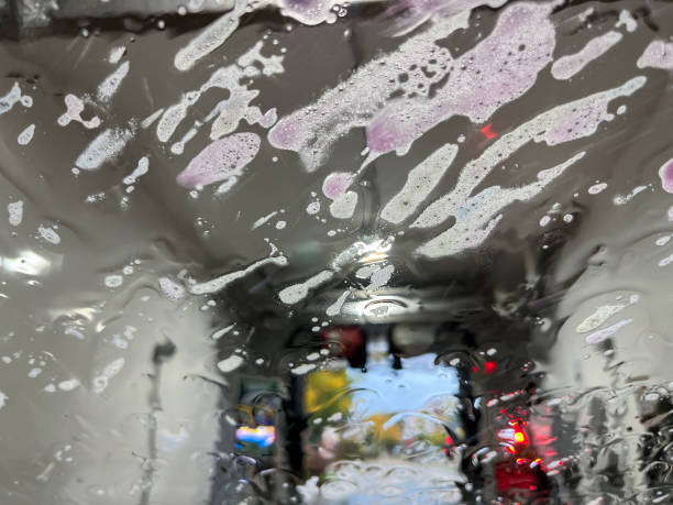 istock Abstract designs from colorful soap suds on a windshield during a car wash 1434238471