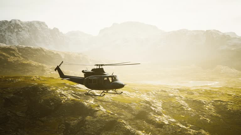 slow motion Vietnam War era helicopter in mountains