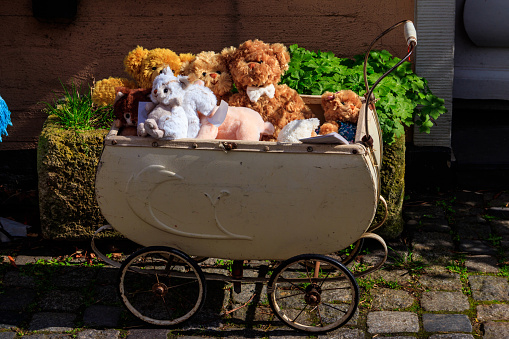 Teddy bears and toys in the vintage baby carriage