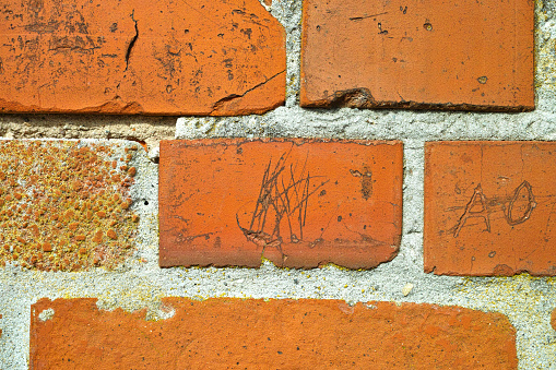 Old repaired weathered redd brick wall for background, Brick wall. Brick wall texture. brick wall background. bricks wall pattern. Texture brick wall of beige color. Brick pattern, Background of brick. Orange brick. Antique brickwork. Restoration.