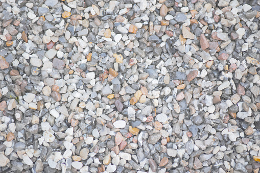 Stone pattern abstract ravel texture small stones, little rocks, pebbles in many shades of grey, white, brown, pink colour in close-up for granite texture background