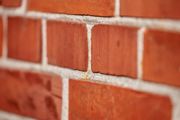 Old repaired weathered redd brick wall for background, Brick wall. Brick wall texture. brick wall background. bricks wall pattern. Texture brick wall of beige color. Brick pattern, Background of brick. Orange brick. Antique brickwork. Restoration.