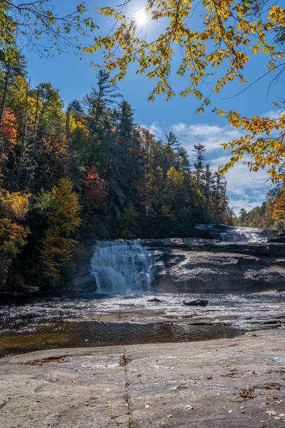 beautiful fall foliage around triple falls in dupont state recreational forest near asheville north carolina usa - triple falls fotos imagens e fotografias de stock