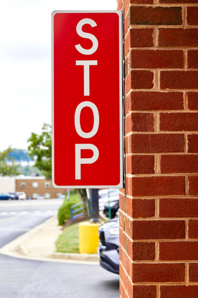 istock Stop sign mounted on the side of a on brick wall 1434250487