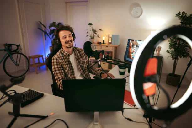 istock Laughing man host streaming podcast in studio 1434250808