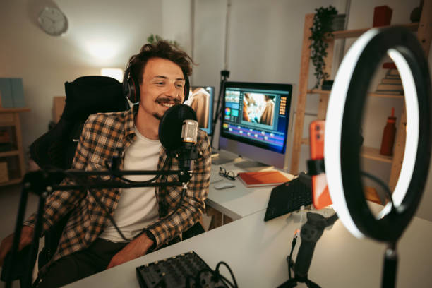 Laughing man host streaming podcast in studio stock photo