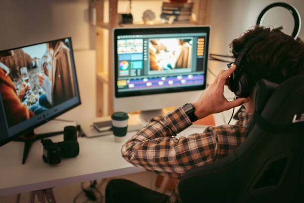 Male video editor working at home Young casually clothed editor working from home office setup editing equipment stock pictures, royalty-free photos & images