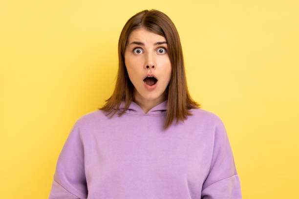 istock Woman looking with shocked expression to camera, sees something astonishing. 1434251590