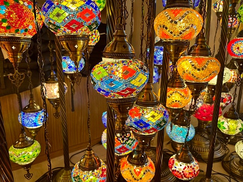 Close-up of oriental lamps in multicolored glass mosaic suspended in a souk