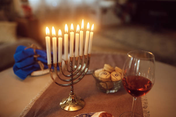 istock Lit menorah candles  on the table during Hanukkah holiday. 1434253207