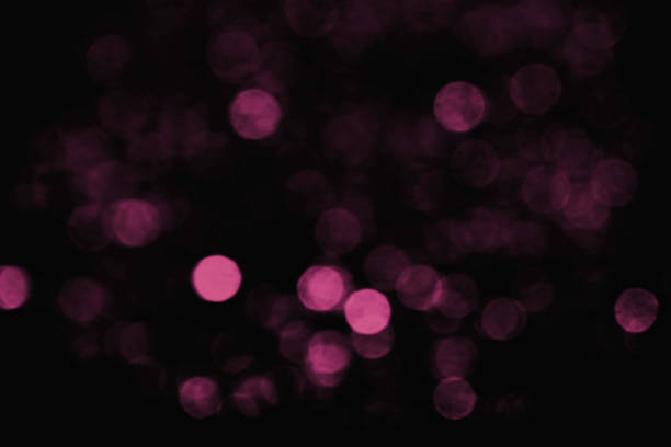 Horizontal blury purple light bokehs on black background