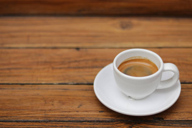 istock Espresso coffee in white ceramic cup on wooden table background. 1434265422