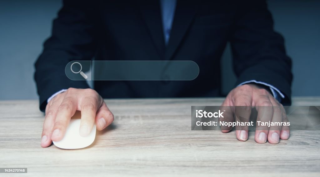 The businessman points to the symbol of Search Engine Optimization SEO Networking Concept.Searching Browser of Internet Data Information with an empty search bar. Adult Stock Photo
