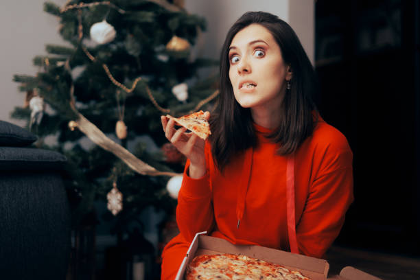 istock Funny Woman Spending Christmas Alone Eating Pizza 1434271646