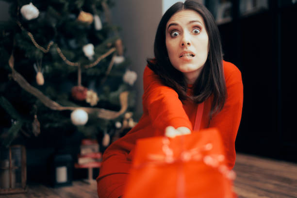 istock Funny Girlfriend Handing out Her Present on Christmas 1434271649