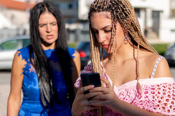 istock Teen ignoring her mom while looking at her phone or while texting messages 1434271686