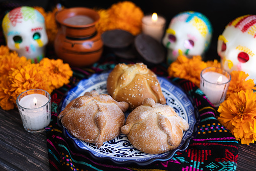 Mexican bread on Altar with sugar skull and hot chocolate traditional food for Celebration of Mexico's Day of the Dead