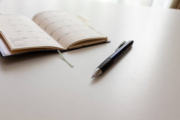 istock Notebook and ballpoint pen on the white table 1434274018