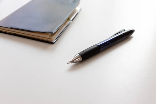 istock Pocket book and ballpoint pen on the white table 1434274020