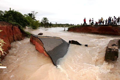 prado, bahia, brazil - april 7, 2010: people using canoe to cross a flooded river due to flooding in the city of Prado