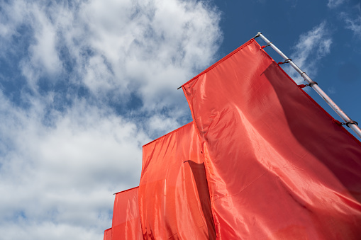 Red flags flying under the blue sky
