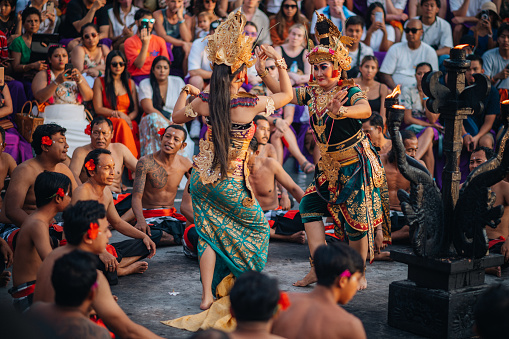 Uluwatu Bali, Indonesia - October  16, 2022:  Kecak dance is a traditional ritual of Bali. A Balinese actor performs in the Kecak ceremony. Also known as the Ramayana Monkey Chant, it is a retelling of a great battle from the Ramayana of Hindu lore.