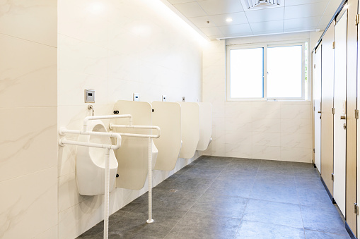 Men toilet - clean urinals in a public restroom.