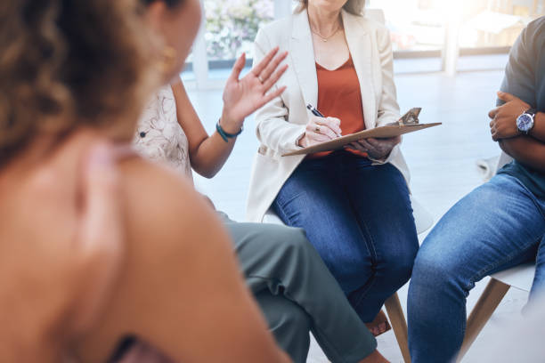 istock Psychologist therapy group support, writing notes stress anxiety and empathy listening to patient speaking. Mental health grief counseling, psychology mind wellness and therapist communication help 1434285534