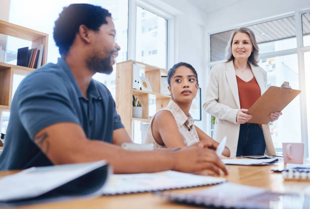 istock Training, workshop and coaching with a female leader, manager or boss in a meeting with a business man and woman employee. Collaboration, planning and strategy with a team at the office with a mentor 1434286454