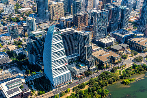 Buildings along the Colorado River in downtown Austin, Texas highlighting the unique architecture of the new Block 185 office tower shot from an altitude of about 1500 feet over the city.