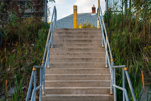 Cement Stairwell with Metal Railings and a Cement Post at the top